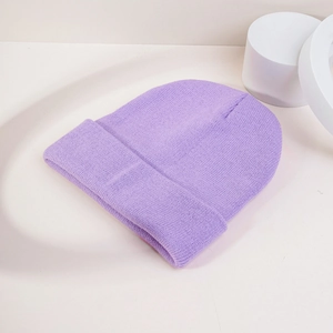 Close-up of lavender knit beanie with fine ribbing texture on a minimalist background