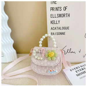 Close-up of pink mini bag with pearl handle, sequin heart and green felt flower detail