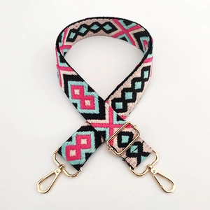 Detail of adjustable 3.8cm embroidered jacquard bag strap with golden metal lobster clasps
