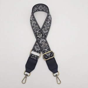 Detail of adjustable 38mm embroidered canvas bag strap with retro jacquard floral patterns