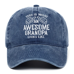 Macro detail of 'Awesome Grandpa' white embroidery on navy blue washed denim cap