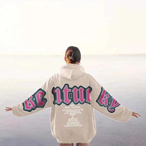 Beige oversized hoodie with pink GENTURKY letter print on the back in a scenic view