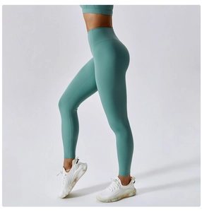 Detail view of high-waisted mint green yoga pants showcasing seamless lift and stretch fit