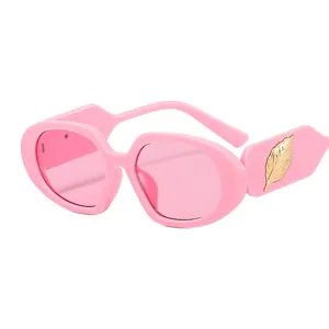 Pink oval frame sunglasses for women with golden leaf decoration on temples