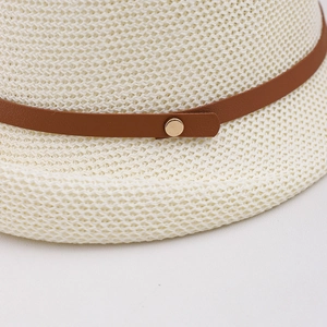 Detail of breathable hollow-knit sun hat featuring a brown faux leather band and gold stud