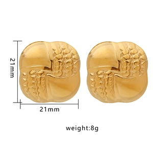 Detail of gold textured earrings with 21mm dimensions and 8g weight specification