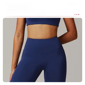 Detail of high waisted compression waistband on navy yoga flare pants for tummy control
