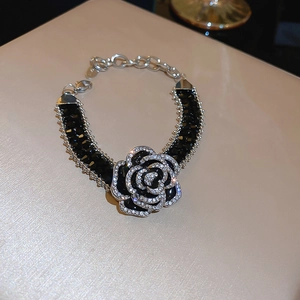 Detail view of camellia flower bracelet with black faceted crystals and pavé rhinestones