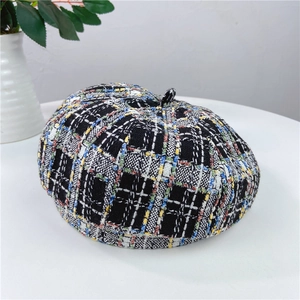 Detailed close-up of a colorful plaid tweed beret with intricate woven texture and top button