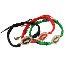 Handmade woven Virgin Mary bracelets in black, red, and green with crystal details