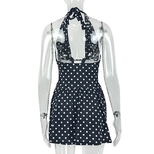 Detailed back view of a navy blue polka dot halter swimsuit with a tie-back design
