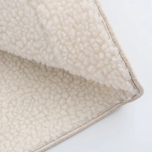 Macro shot of white sherpa fleece lining and beige suede trim for casual jacket