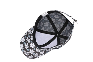 Detail view of the floral baseball cap featuring breathable black mesh lining and wash label