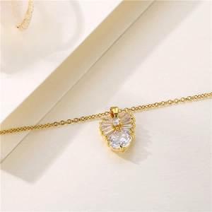 Golden necklace with a diamond-studded bow pendant and sparkling zircon accents