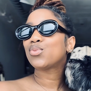 Close-up of stylish black oval sunglasses worn by a model for a trendy retro look