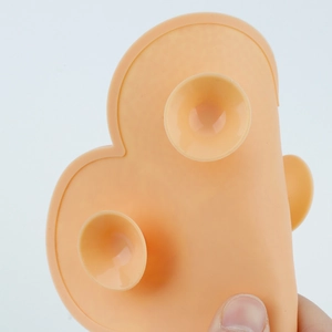 Flexible flower-shaped silicone makeup brush cleaning pad with suction cups in peach color
