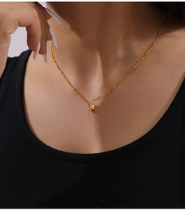 Detailed view of oval zircon pendant on gold-plated stainless steel chain necklace