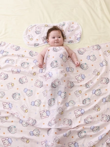 Bamboo cotton muslin swaddle blanket with pink bunny patterns and matching pillow