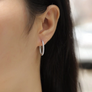 Close-up of minimalist double-row moissanite hoop earrings worn by a model for a refined look