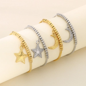Detail of beaded star and moon charms on adjustable stainless steel bracelets