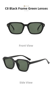 Detail view of black frame sunglasses with dark green lenses and golden ring ornaments