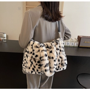 Detail of soft leopard faux fur tote bag with wide strap on a model in a minimal setting