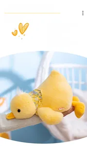 Close-up of yellow plush duck toy with floral Summer scarf and soft fur texture