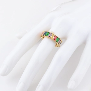Detail of 18K gold ring with multi-color baguette-cut cubic zirconia in rainbow palette