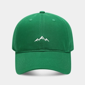 Detailed close-up of mountain embroidery on a green twill cotton baseball cap