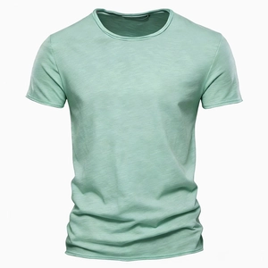 Close-up of mint green slub cotton fabric texture on a men's short sleeve V-neck t-shirt