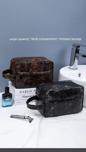 Waterproof PU leather toiletry bags in brown and black on a marble bathroom vanity