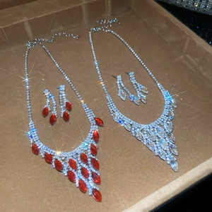Macro shot of a luxury jewelry set with red and clear crystals in teardrop design