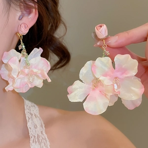 Detailed view of handmade pink chiffon petal drop earrings worn on the earlobe