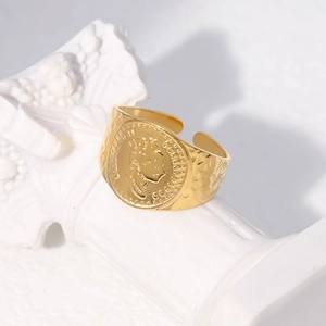 Close-up of golden adjustable coin ring featuring Queen Elizabeth II relief on marble