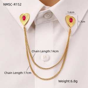 Detail of vintage heart collar clips with red stones and layered chains on shirt