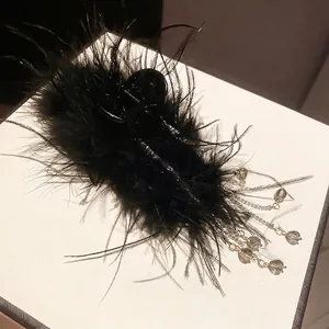 Luxurious black feather hair claw clip with crystal tassels and metallic chains