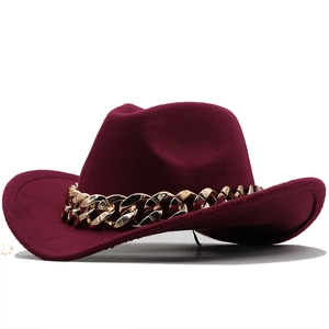 Detailed close-up of dark burgundy wool felt fedora with a chunky gold chain trim