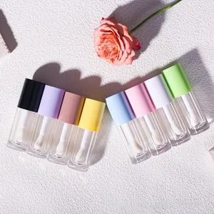 Detail view of 6ml transparent lip gloss tubes with large brush and colorful pastel caps