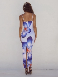 Detailed back view of a summer floral maxi dress featuring a slit and a cross-back design