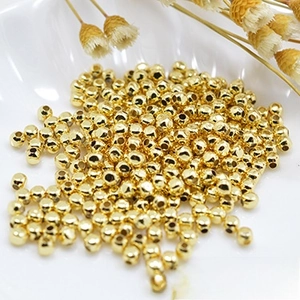 Close-up of golden bamboo-style OT toggles and connectors in a white shell dish