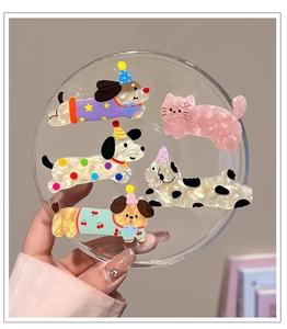 Close-up of pearlized acrylic animal hair clips with cute dog and cat designs