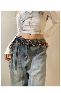 Retro punk brown leather waist chain with silver rivets and metal rings on denim