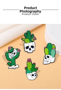 Detailed view of four punk skeleton cactus enamel pins on a warm orange background