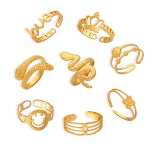 Set of eight gold geometric titanium steel rings with snake, sun, and crown motifs