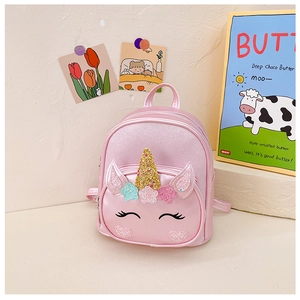Detail view of pink unicorn backpack showing golden sequin horn and glitter ears