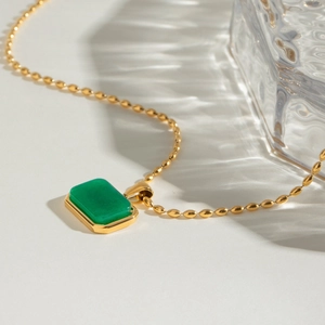 Macro view of 18k gold plated stainless steel necklace with green tiger eye pendant