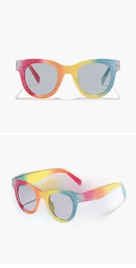 Close-up of kids round glitter sunglasses with rainbow gradient and dark grey lenses