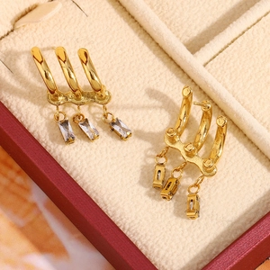Detail of 18K gold-plated stainless steel earrings with three vertical zircon stones