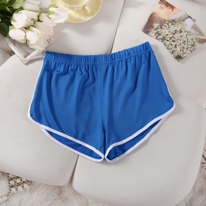 Close-up of blue sports shorts with white trim and elastic waistband on leather background