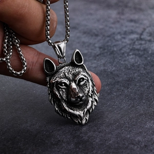 Gothic wolf head pendant necklace in vintage silver finish with rustic stone background